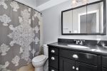 Master bathroom has a large vanity and a shower tub combo